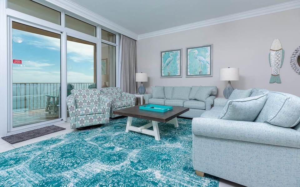 Relax in the inviting living area, featuring a queen sofa sleeper, and enjoy the fresh breeze from the balcony