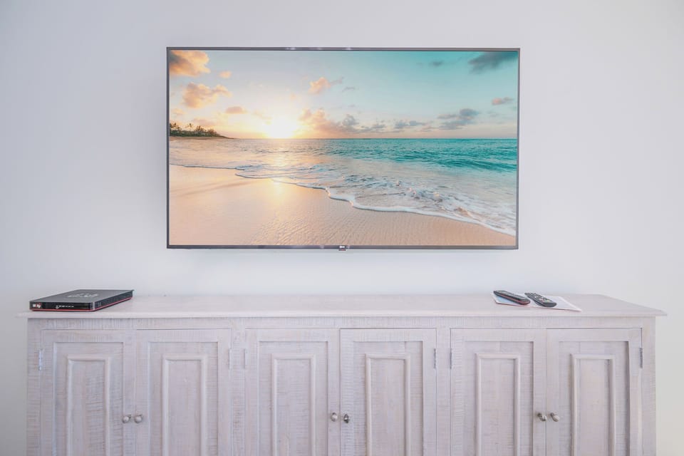 Stream your favorite shows on the large TV while relaxing on cozy furnishings that embrace you in comfort