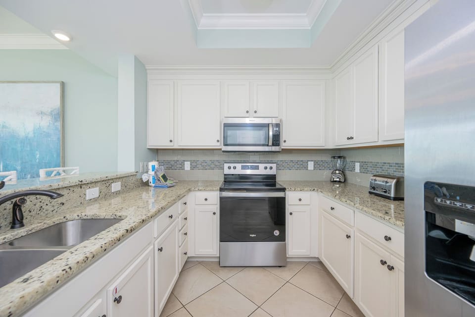 Create culinary delights in this stylish kitchen, where stainless appliances meet inviting countertop space