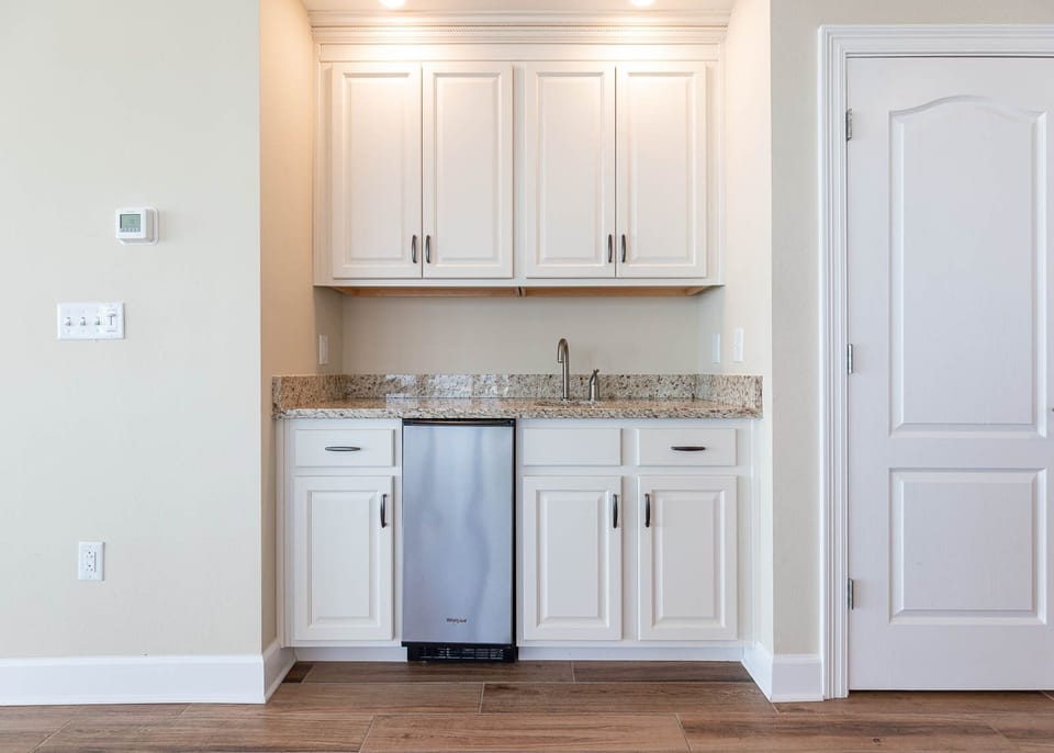 Mix and mingle at the wet bar, pouring chilled drinks to complement your beachside retreat