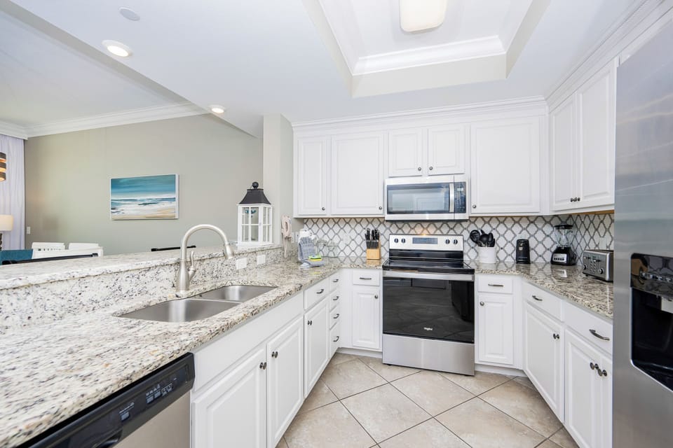 Craft delicious coastal-inspired meals while enjoying the inviting ambiance of this beautiful kitchen