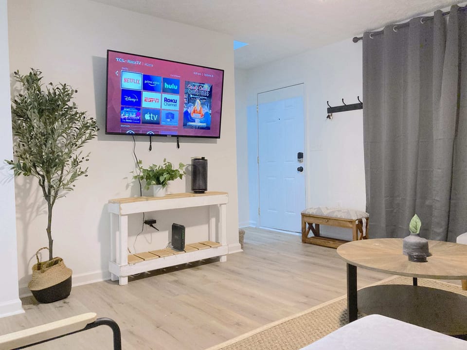 Living room with a 55 inch TV including Netflix, Hulu, Disney+ and ESPN+