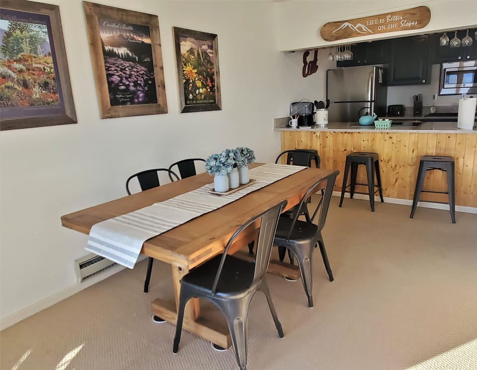 The dining area is adjacent to a bar that backs up to the kitchen.