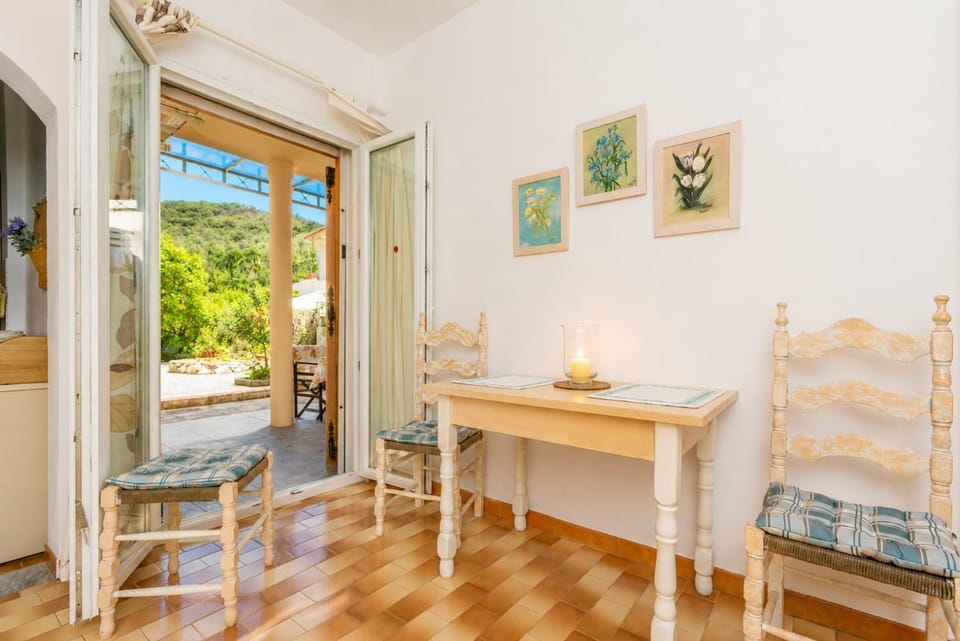 Living room with WiFi Internet, Satellite TV, DVD player, dining area, and terrace access