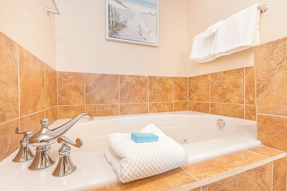 Sink into warm, soothing water in your private jetted tub—perfect for unwinding after a day of adventure. Fresh towels and coastal touches make this your personal spa retreat.