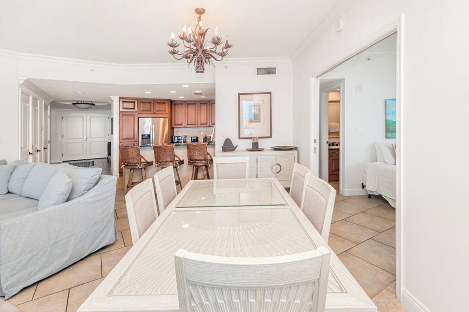 Step into your spacious, sunlit haven where elegant coastal design meets comfort. The open layout flows seamlessly from living to dining to kitchen, inviting you to gather, unwind, and savor every moment of your vacation.