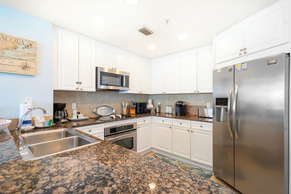 Your fully equipped kitchen features granite countertops, stainless steel appliances, and everything you need to create memorable meals during your stay.