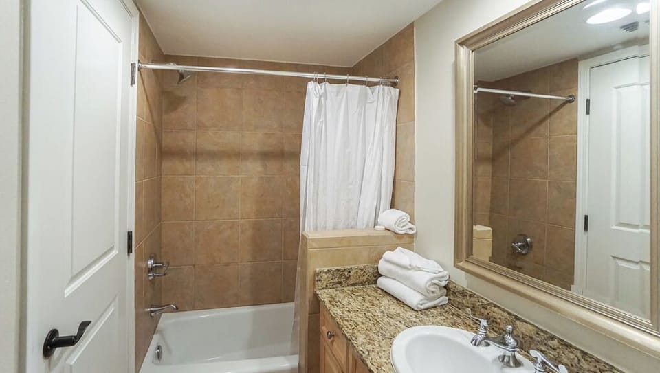 Your private bathroom awaits with a full tub-shower combo, fresh towels, and everything you need to unwind after a day of adventure.