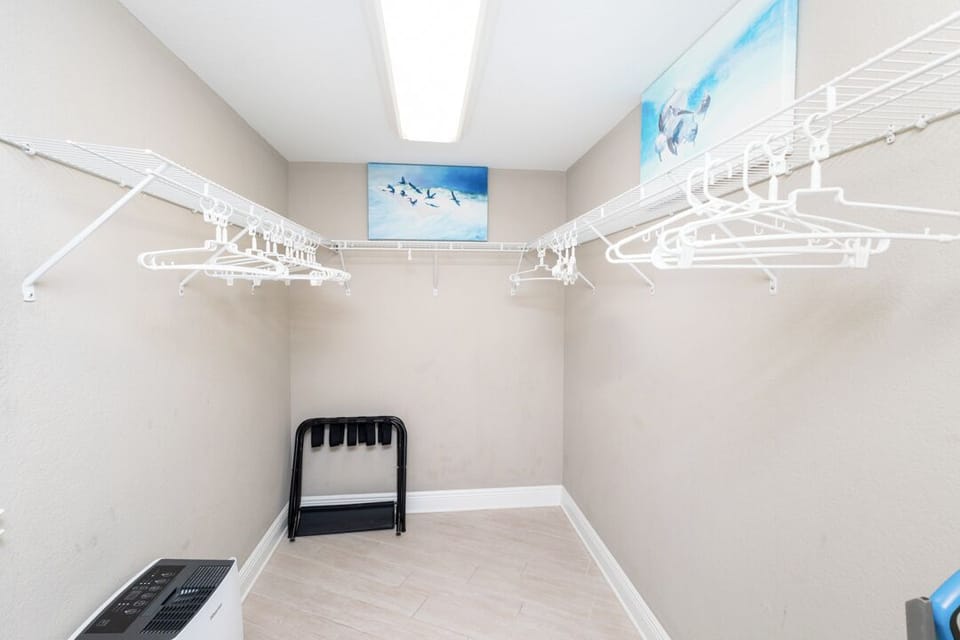 A spacious walk-in closet with generous hanging space and bright natural light to keep your wardrobe organized throughout your stay.