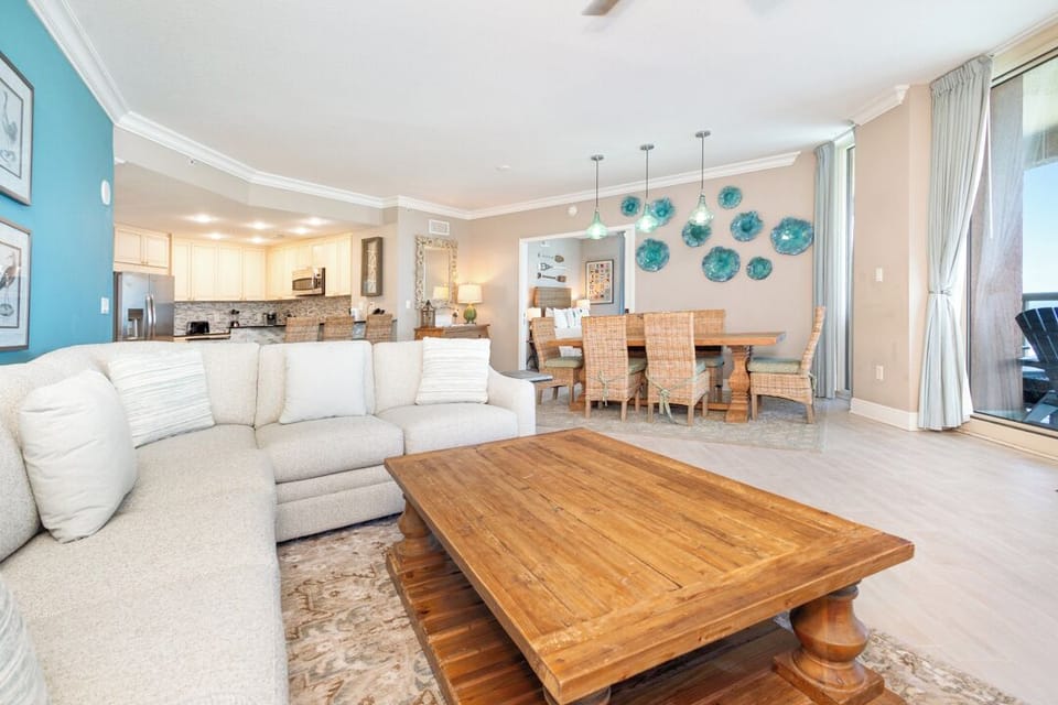 Settle into your inviting open-plan living space, where coastal hues and warm wood tones create a perfect retreat. The fully equipped kitchen, cozy dining area, and comfortable lounge flow seamlessly, ideal for gathering and relaxing together.