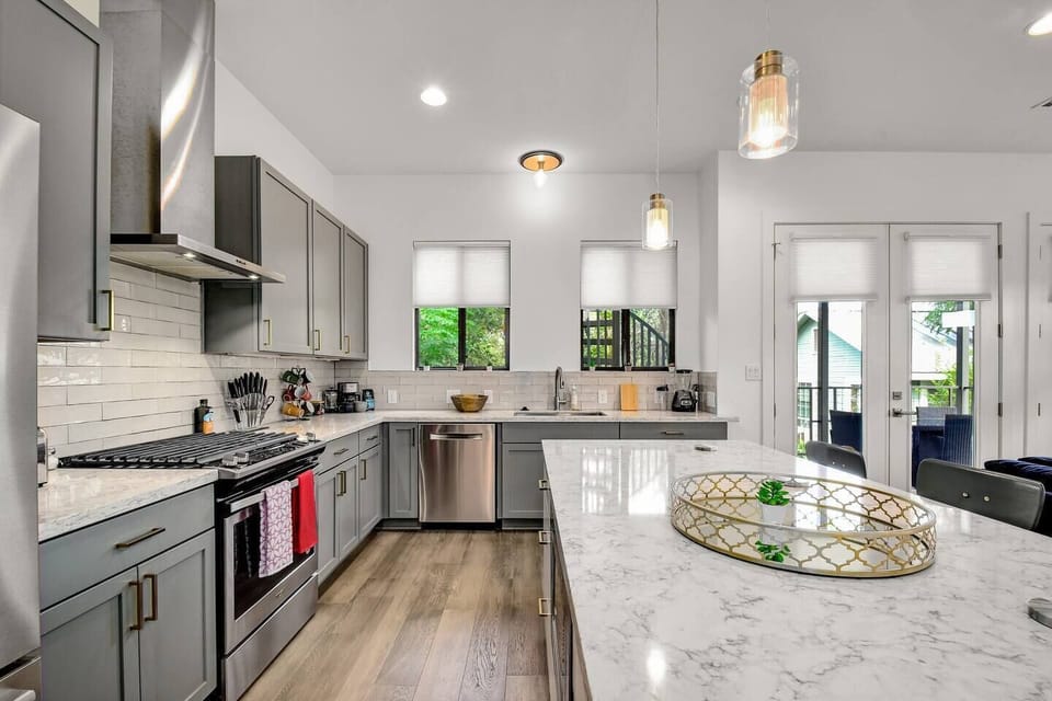 Modern kitchen with spacious marble-topped island, perfect for gourmet cooking and entertaining.