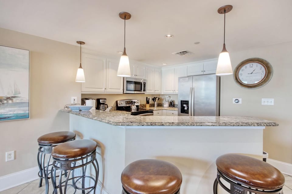 Bright, open kitchen with cozy breakfast bar seating