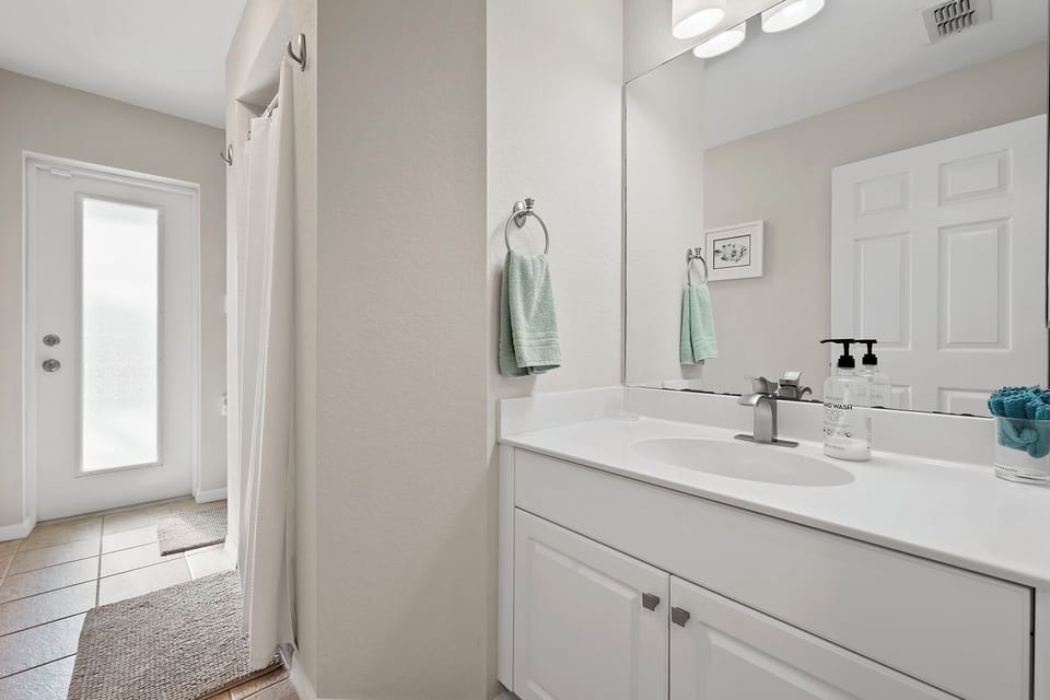 The guest bathroom has a shower and doubles as the pool bath for easy rinse-offs after a swim.