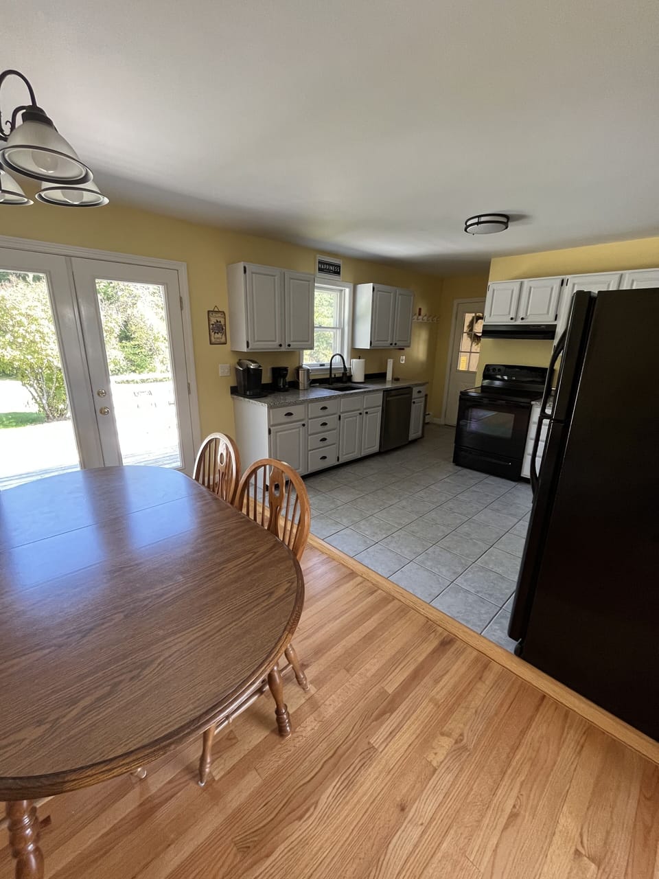 Dining area with view onto back deck and backyard. 