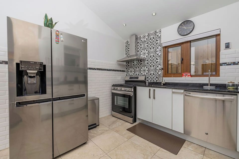 Well-equipped kitchen with stove, oven, dishwasher, and full-size fridge.