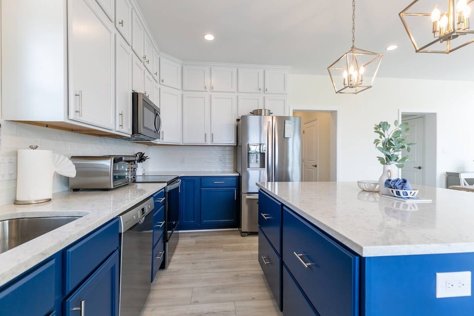 The kitchen is fully-stocked with cookware, plates, silverware and glasses.