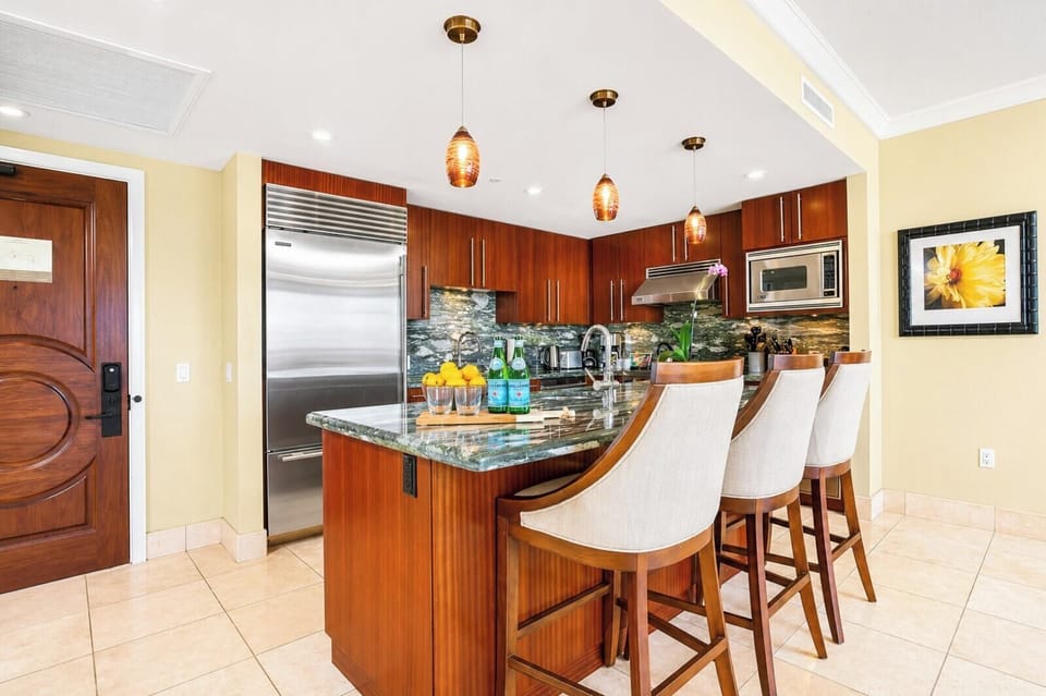 Granite countertops and bar seating make your kitchen both functional and social, ideal for casual breakfasts or evening drinks.
