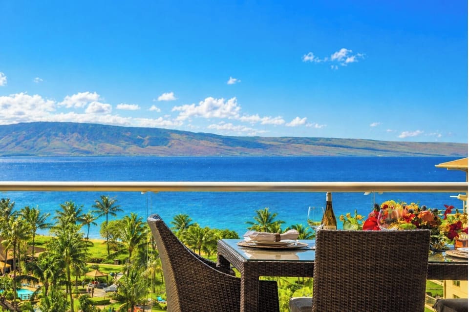 Bright blue skies and sweeping ocean vistas frame your elevated balcony, a perfect spot for morning coffee with fresh island air.