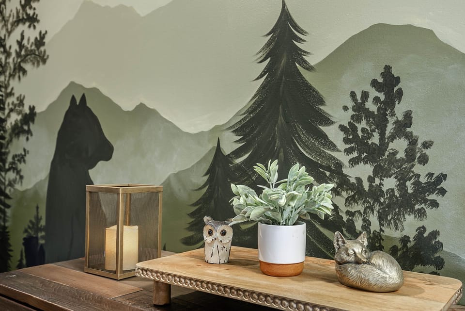 Primary Bedroom with King size bed, accent wall, and hand painted mural. 