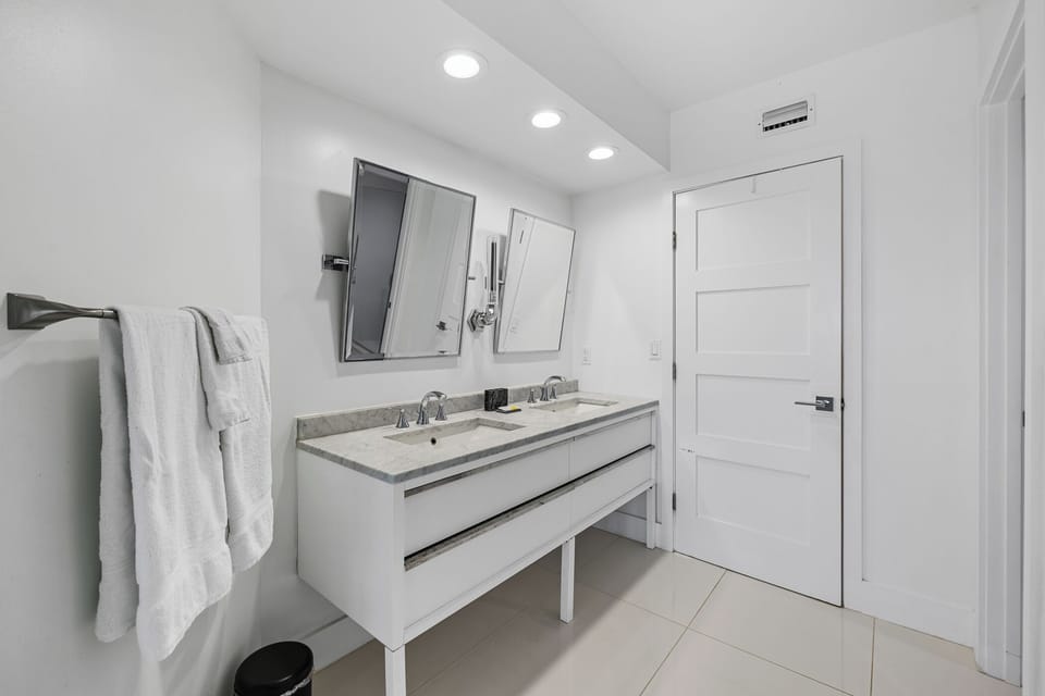Beautifully updated primary bathroom features a walk-in shower and a standalone tub.