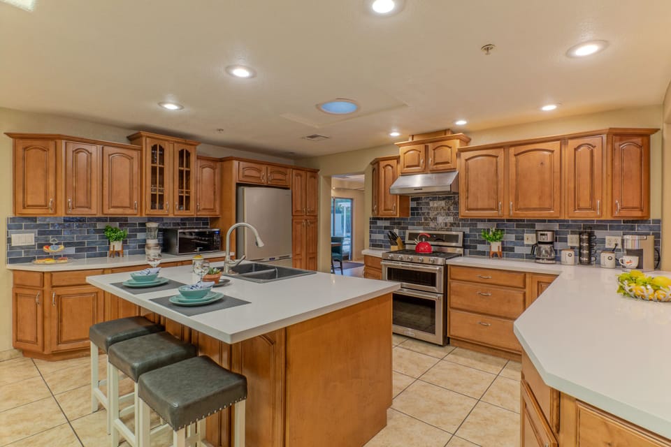 Modern kitchen has plenty of space for preparing and serving home cooked  meals.