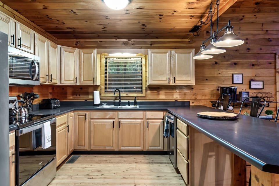 Kitchen stocked with dishware, silverware, pots/pans, blender, toaster & more.