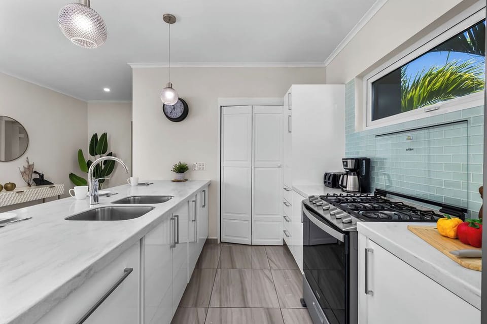 The fully equipped kitchen offers everything you need to cook at home, including modern appliances, ample counter space, and a dining area perfect for family meals or group gatherings.