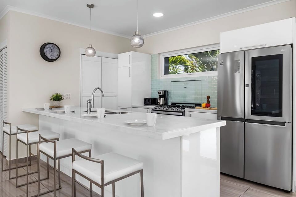 The fully equipped kitchen offers everything you need to cook at home, including modern appliances, ample counter space, and a dining area perfect for family meals or group gatherings.