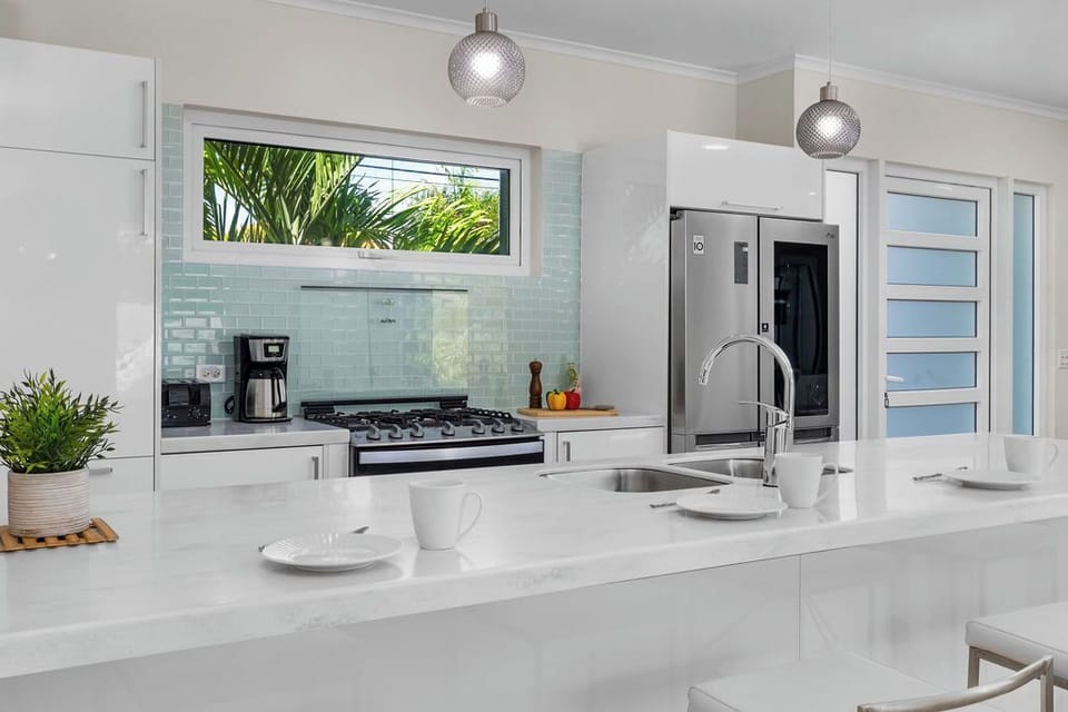 The fully equipped kitchen offers everything you need to cook at home, including modern appliances, ample counter space, and a dining area perfect for family meals or group gatherings.