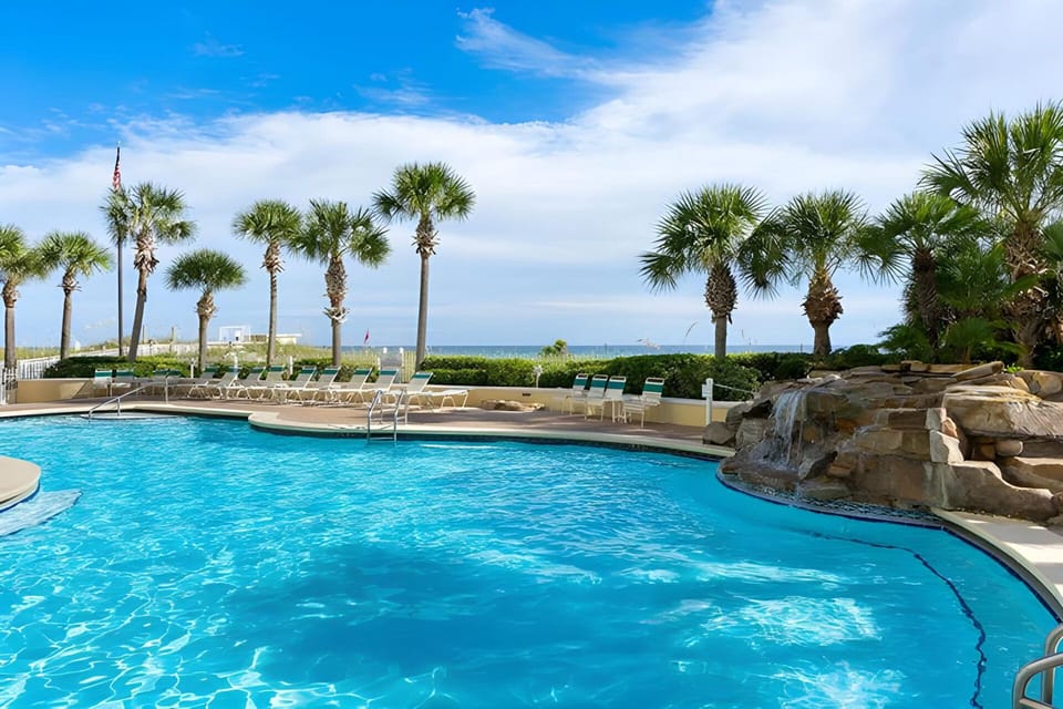 Beachside freeform heated pool w/ waterfall and hot tub. Gated access, restroom.