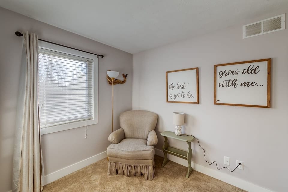 Kids room with chair for reading books, or nursing. (Pack n' play in closet)