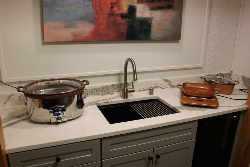 New sink, countertop, dish washer. Programmable crock pot. Copper Chef hot plate