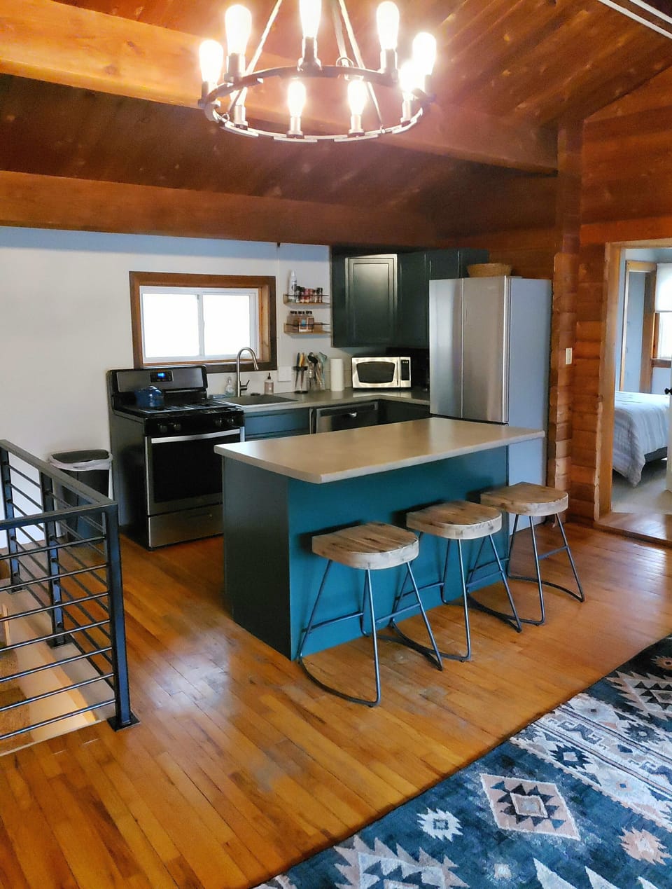 Open concept kitchen/living area. Bar stools offer seating for 3 at the island.