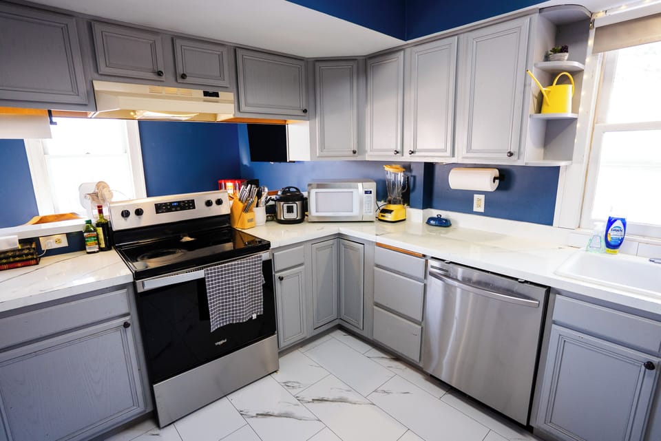 Full kitchen with breakfast bar, stainless appliances and cooking basics.