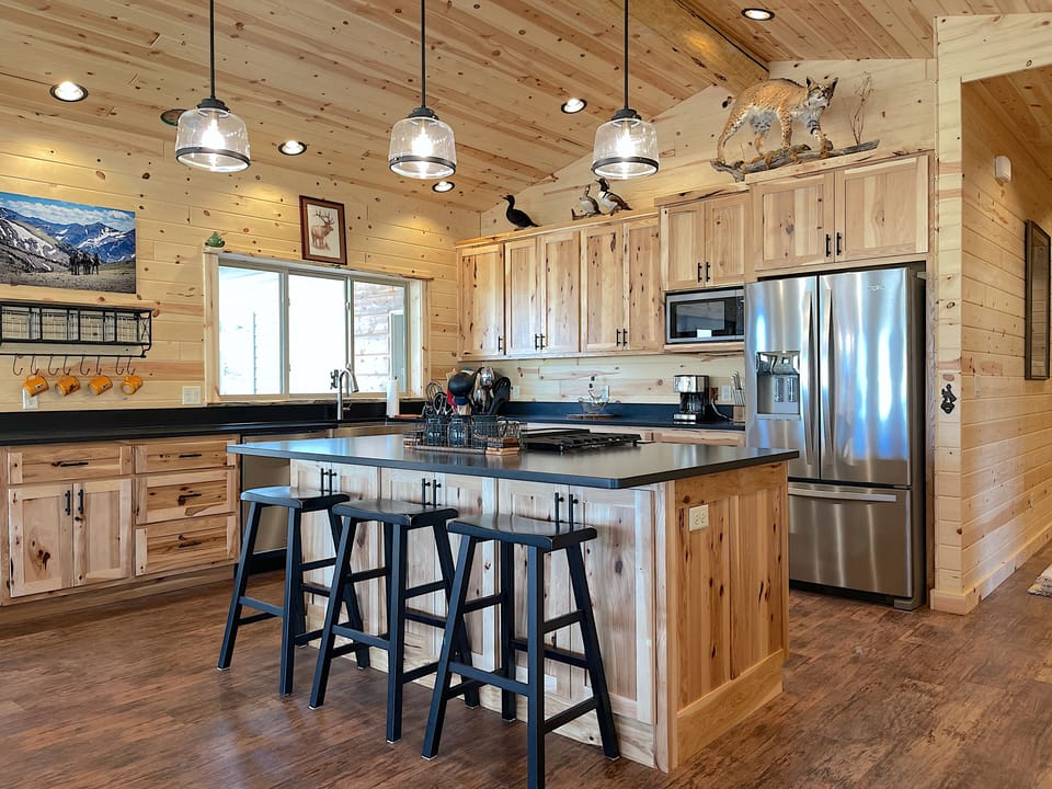 The large open kitchen with breakfast bar island makes a great gathering hub