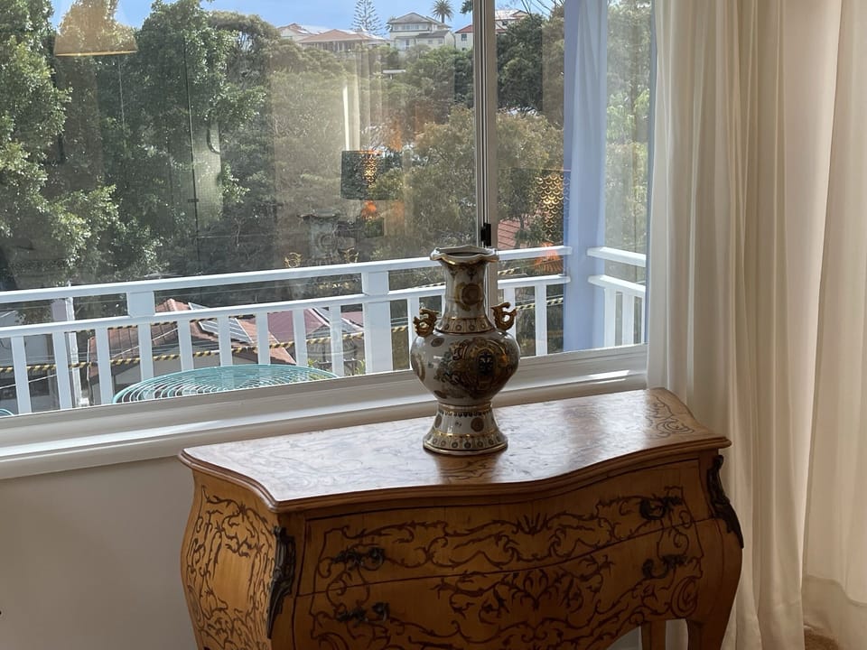 View through master bedroom of verdant neighbourhood