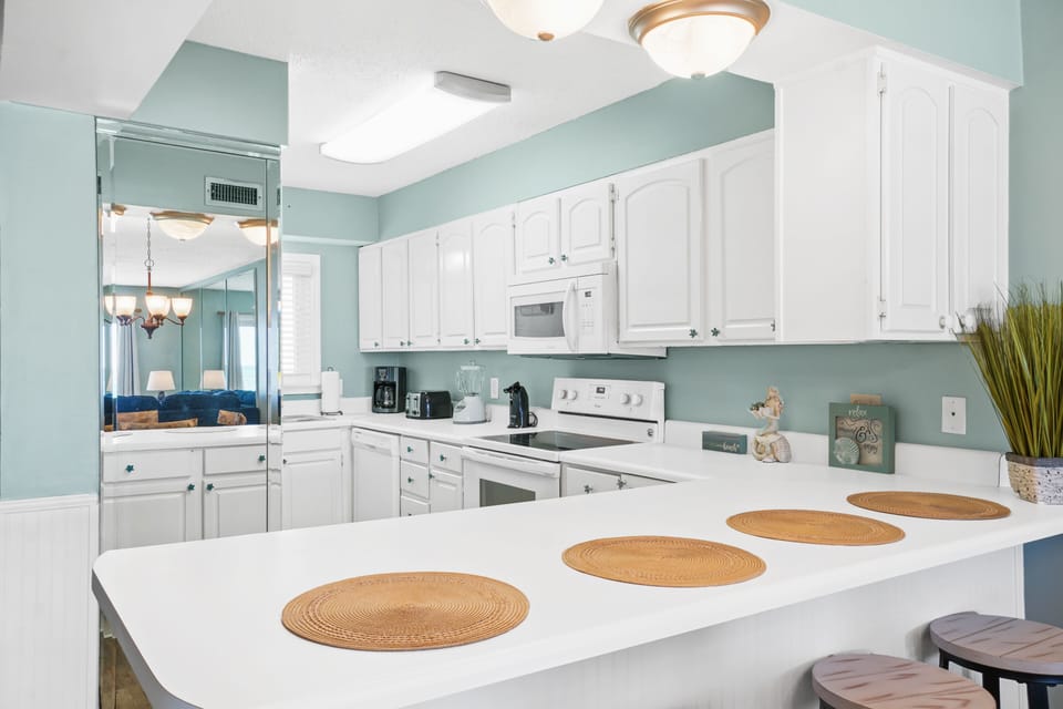 Breakfast bar area with 4 barstools and open kitchen for making home cooked meals!