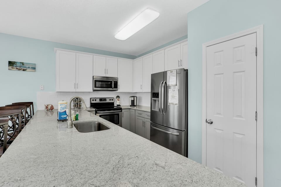 Your fully-equipped kitchen features granite counters, stainless steel appliances, and everything you need to create memorable vacation meals.