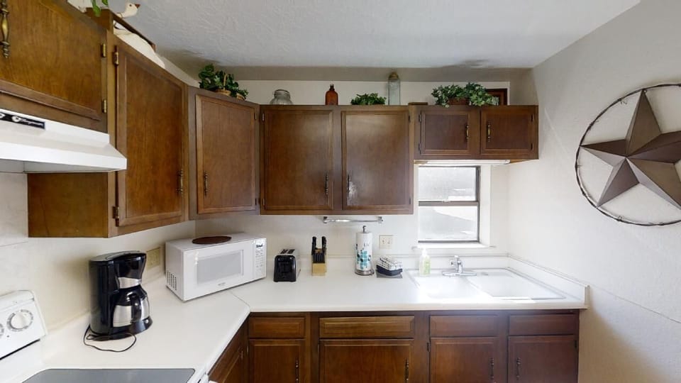 Step into your fully equipped kitchen with warm wood cabinetry, modern appliances, and plenty of counter space to prepare your favorite meals during your stay.