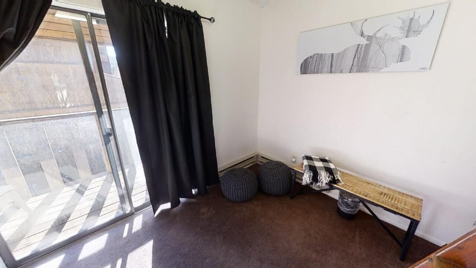 A serene space bathed in natural light, featuring minimalist décor and rustic wood touches. Your peaceful corner to unwind and enjoy the view.