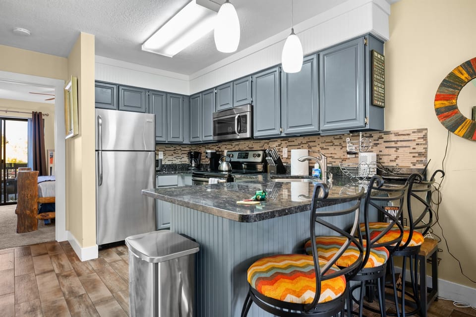 Updated kitchen with bar seating — warm and inviting for cooking and gathering.
