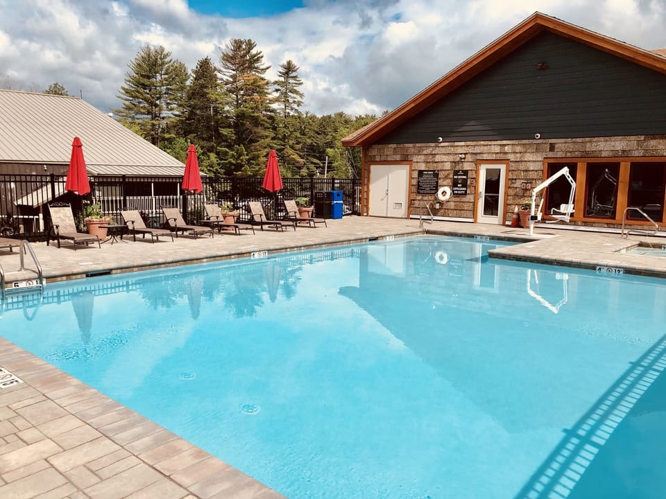 Heated 4-season pool with a hot tub and amenities building