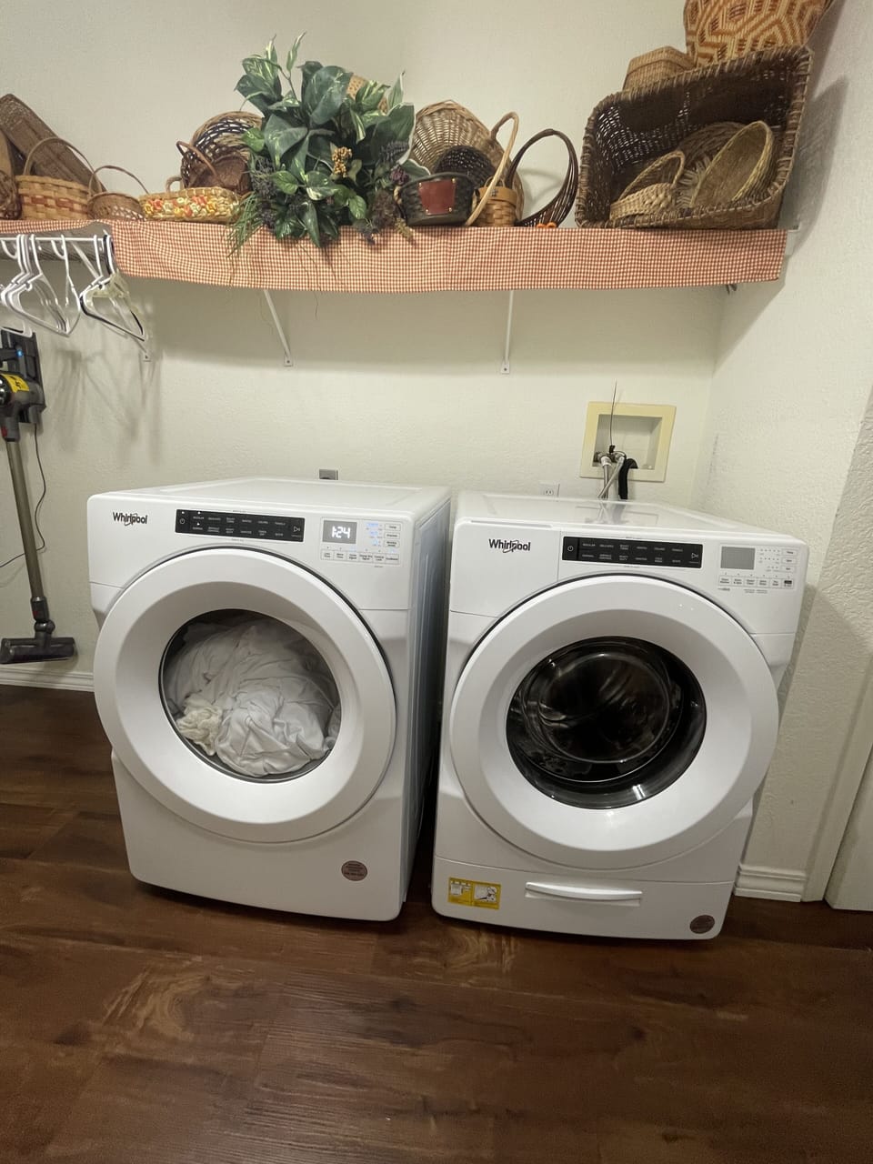 Large front loading washer and dryer with laundry soap and dryer sheets.
