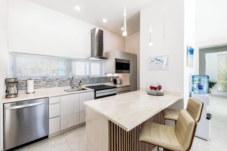 Full kitchen with induction cooktop, range with air fry built in, and dishwasher