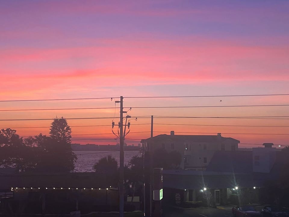 Magenta sunrise over bay balcony