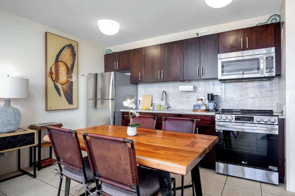 Dine in style! Enjoy meals at the beautiful live-edge wooden table right next to your modern kitchen with granite counters and stainless steel appliances.