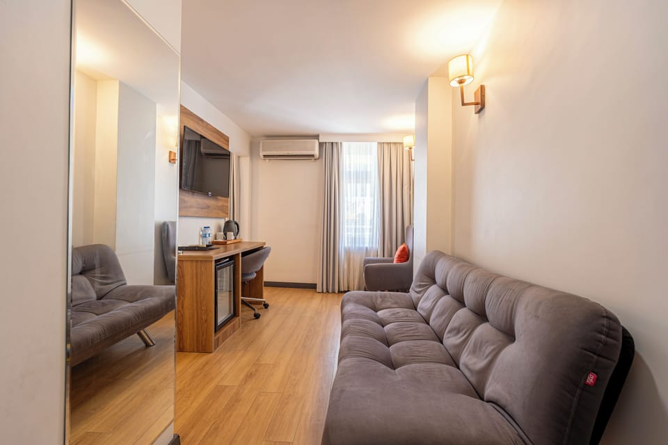 Junior Suite | Living area | 109-inch LCD TV with satellite channels