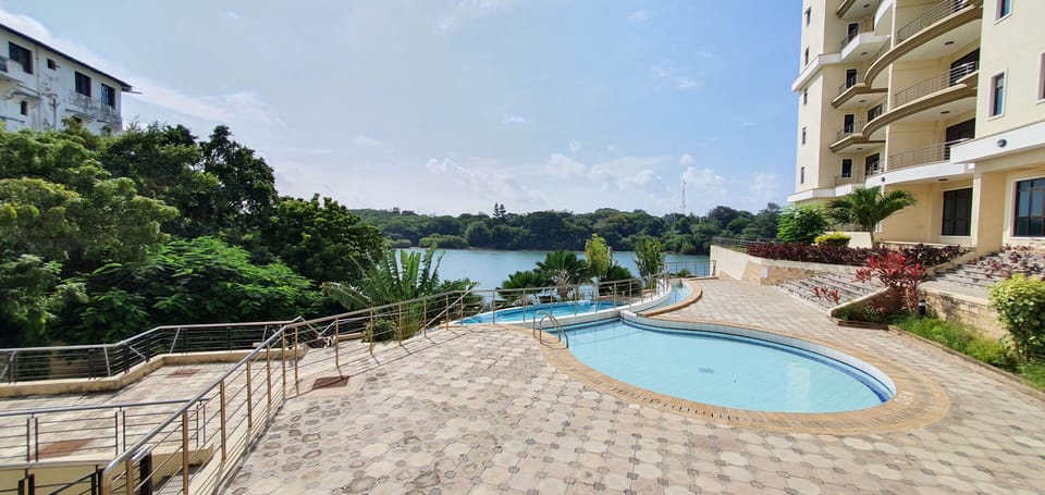 Outdoor swimming pool area with stunning views of local nature and ocean.