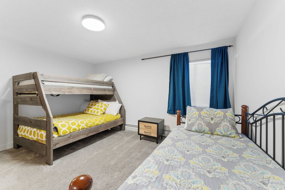 Your family bedroom offers comfortable sleeping with stylish bunk beds and a cozy single bed, perfect for kids and guests.