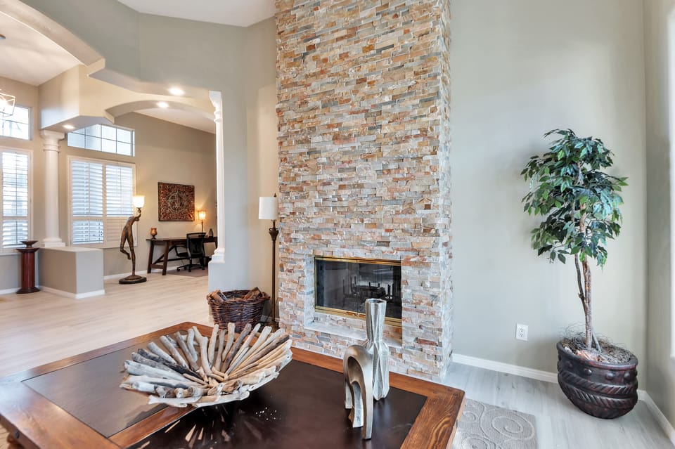 Living Room with beautiful dual sided stone fireplace
